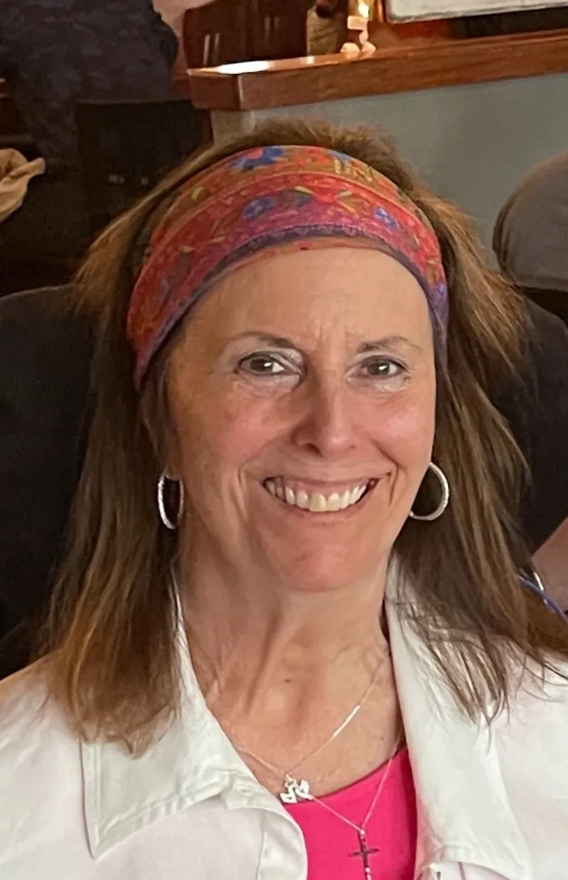 A woman with long hair wearing a headband.