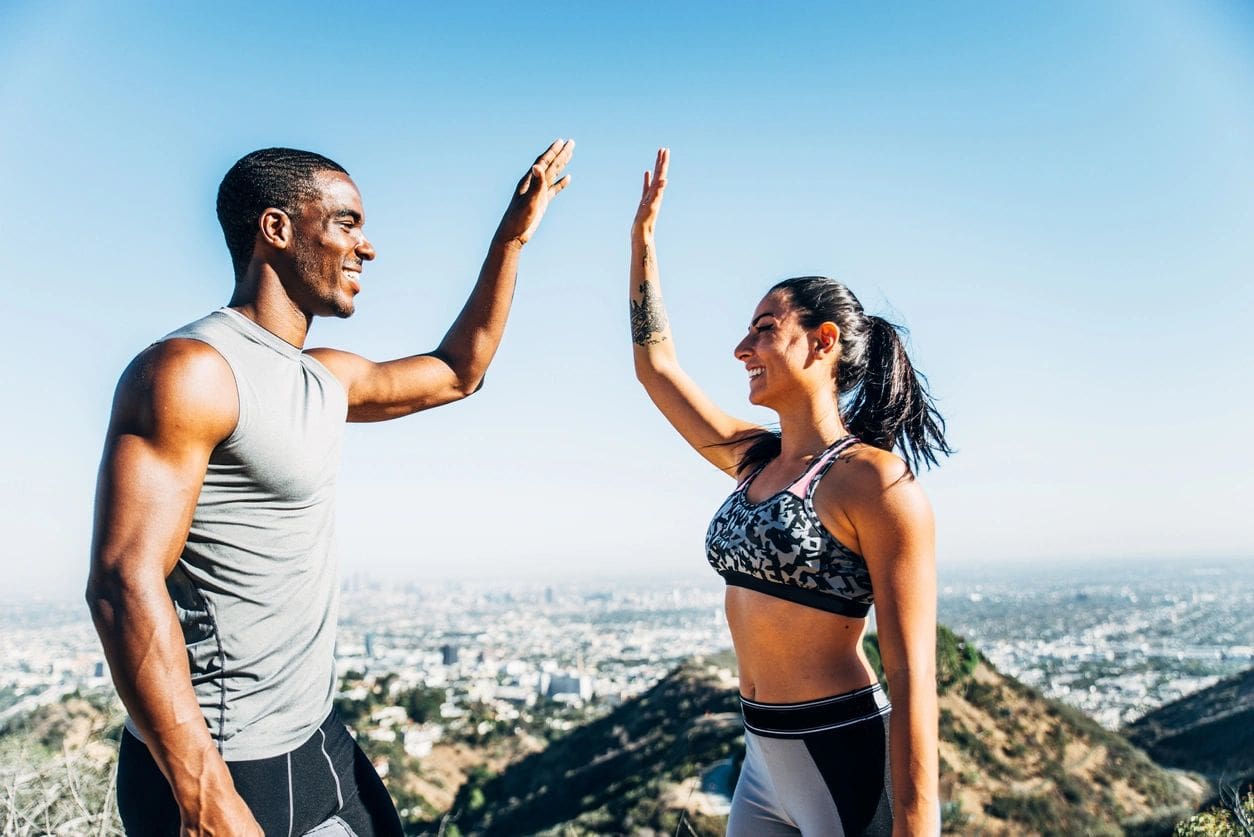 Two people giving each other a high five